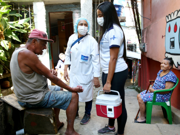 Health workers talk to residents in Rio de Janeiro, Brazil.