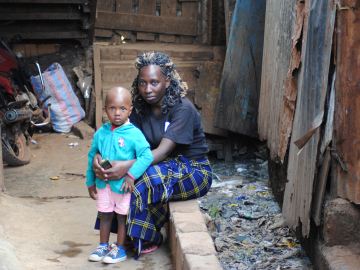 Mary Ndira sist outside their house next to a drainage in Kibera slums on March 2, 2022 Photo-Dominic Kiruli