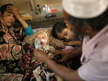 A baby who is suffering from respiratory disease receives treatment inside at Dhaka Shishu Hospital in Dhaka, Bangladesh, February 24, 2021. Syed Mahamudur Rahman/NurPhoto via Getty Images.