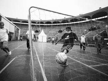 Mario Noa Pariona scores a goal during a soccer match at the Plaza de Acho bullring.