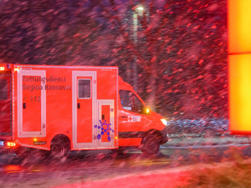 An ambulance drives through Laatzen, Germany in heavy snow during a surge in COVID-19 cases on January 31, 2022.