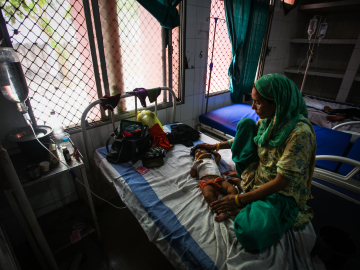 Sahil, a 7-month-old child suffering from diarrhea, lies in a bed at the district hospital on May 21, 2022 in Mirzapur, Uttar Pradesh, India.