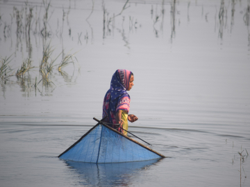 Teenager Hasina Begum fishing in the salty Kholpetua River in southwestern Bangladesh. 