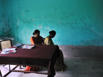Dr. Renu Singh checks a patient for possible signs of tuberculosis in the district TB center in Patna, Bihar, India, on August 10, 2010.