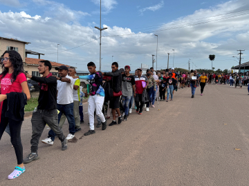 Venezuelan refugees walk after crossing the border between Venezuela and Brazil in the city of Pacaraima, Roraima State, Brazil, on September 13, 2024.