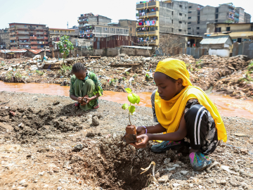 Local teenage girls resident of Kiamako slum take part in planting a tree near a site of homes destroyed by floods along the bank of Mathare river. Nairobi, Kenya, June 5, 2024.