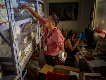 A pharmacist stocks PrEP medicine at a pharmacy in a community center operated by LoveYourself, a nonprofit impacted by the Trump administration's freeze on foreign aid, on February 19, 2025, in Mandaluyong, Metro Manila, Philippines