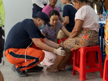 A member of China Search and Rescue Team provides medical consultations for local residents in Mandalay,  Burma (Myanmar),