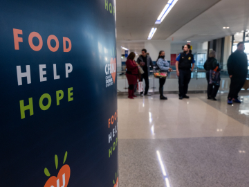 Federal workers impacted by the government shutdown, including TSA officers and air-traffic controllers, line up to receive food parcels at Newark Liberty International Airport, in New Jersey, on October 27, 2025.