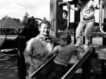 Sue Baker with children on a playground slide