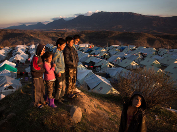 Children look out at the sunset over the Bamarne IDP camp in northern Iraq.