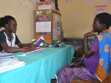 Caroline Akello attending to a mother at Loktelabu Health Centre III, Uganda.