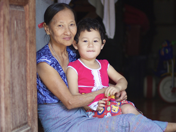 Daw Ngwe Tein is babysitting her 3-year-old grandchild, Blu Nay L'Paw. Blu's mother works as a Medic in the Shoklo Malaria Research Unit (SMRU) in Mae Sot, Thailand. ©Pearl Gan in association with Oxford University Clinical Research Unit, Eijkman Oxford University Clinical Research Unit and The Wellcome Trust.