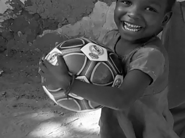 Boy with soccer ball in Kenya