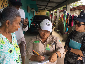An IBM Health Corps team member (right) evaluating the manual data collection process of a Panama Health Department field worker as she interacts with citizens.