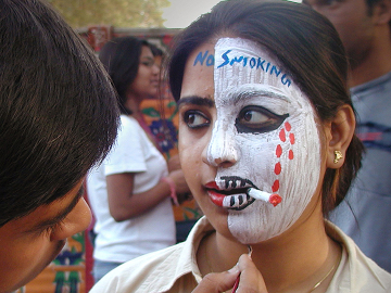 A young woman protests tobacco with face paint during a campaign to prevent cigarette smoking in India.