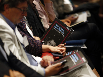 Audience members peruse a new WHO report on NCDs at its May 20 release in Geneva. (Image: Courtesy of Bloomberg Philanthropies)