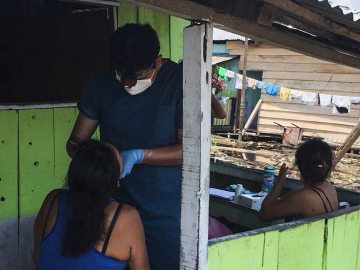 Marco Alarcon, DDS, MS, conducts an oral examination in Peru's impoverished Claverito settlement. 