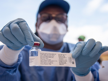 A nurse working with the WHO shows a bottle containing Ebola vaccine in Mbandaka, May 21, 2018.