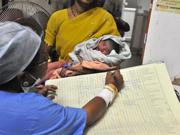 A nurse registers the records of a new born baby boy at Governement Gandhi Hospital in Hyderabad on October 31, 2011.