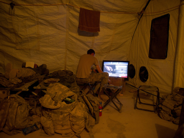 A US soldier plays video games in Lakhokad camp near Kandahar city on November 26, 2010. Image: Martin Bureau/AFP/Getty Images