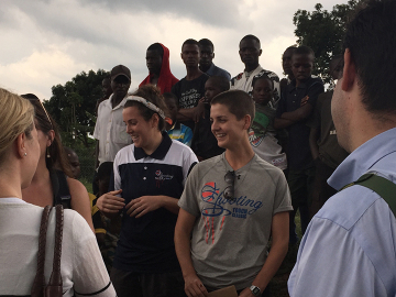 Shooting Touch's Chloe Rothman (center left) and Lisanne Comeau (center right) describe their program to ICFP delegates on a site visit to the Nyamirama health center in Rwanda.