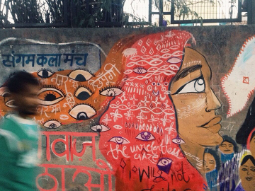 Women painted a wall with eyes that stare back, and the message “We won’t be intimidated by your gaze.&quot;