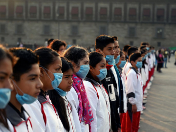 A group of students wear face masks to protect from air pollution during a ceremony at Zocalo Square in Mexico City on May 17, 2019. Alfredo Estrella/AFP/Getty Images)