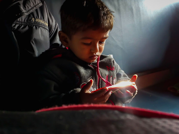 A child watches videos on a mobile device in Burhanpur, India. © 2019 Danish Mansuri, Image Courtesy of Photoshare