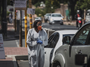 A health worker conducts drive-through novel coronavirus testing in Johannesburg yesterday. Photo: Marco Longari/AFP via Getty Images