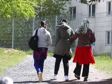 Asylum seekers go for a walk on the grounds of the initial reception centre in Suhl, Germany which is being converted into an isolation and quarantine area. May 12, 2020.  Image: Bodo Schackow/picture alliance via Getty