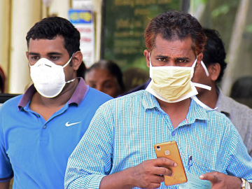 Indian residents wear face mask outside the Medical College hospital in Kerala, India on May 21, 2018, during a Nipah virus outbreak. Image: AFP via Getty