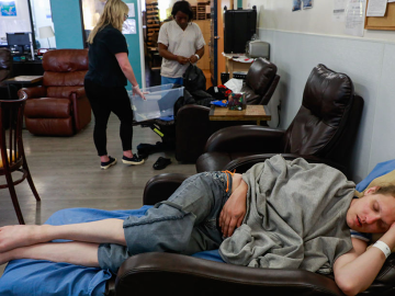 A woman sleeps at the Dore Urgent Care clinic, a crisis drop-in center for mental health needs in San Francisco, California, June 10, 2019. Image: Gabrielle Lurie/San Francisco
