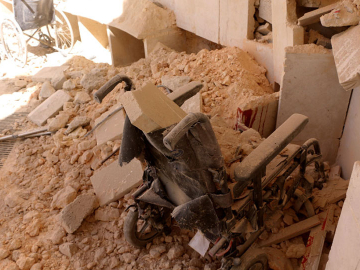A wheelchair sits in rubble following an attack targeting a hospital in the Idlib de-escalation zone in the western Aleppo countryside, Syria, March 21, 2021.