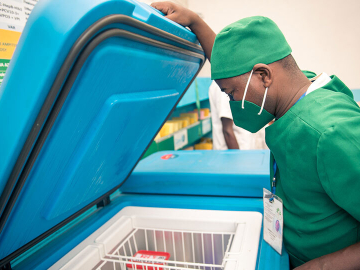 A man opens a vaccine storage cooler in Madagascar