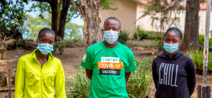 sther Sambiri, left, stands with fellow vaccine advocates outside the Nyanga, Zimbabwe, district government office on Dec. 16, 2021. Image: Farai Mutsaka