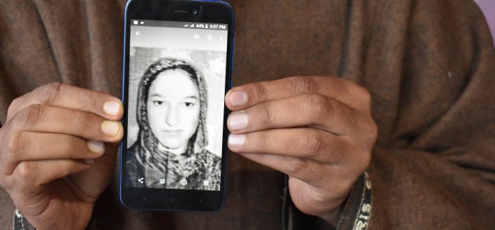 Javed Ahmed Padroo displays a photo of his wife, Ruqiya Javed, on his cellphone. Anantnag, Kashmir, April 21. 