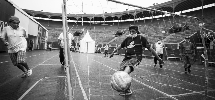 Mario Noa Pariona scores a goal during a soccer match at the Plaza de Acho bullring. 