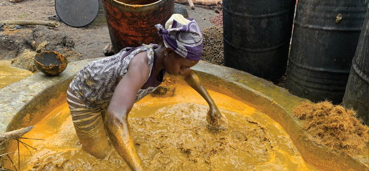 A woman at Akinlapa oil farm filters the fresh palm fruits. Abiodun Jamiu