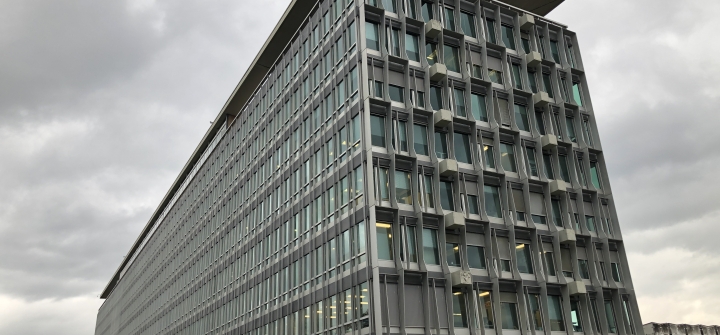 A side view of WHO headquarters on a cloudy day in 2019 in Geneva.