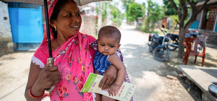 A mother carrying her young child with a health card arrives a rural health center in Brindaban village in Bihar on June 19. Pradeep Gaur/SOPA Images/LightRocket via Getty