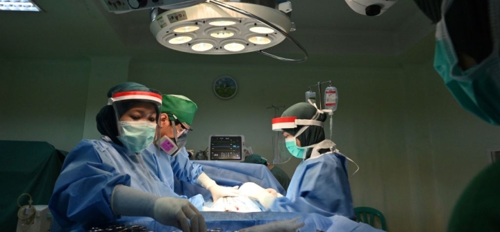 An obstetric team performs a caesarean section delivery at the RSIA Tambak maternity clinic in Jakarta, Indonesia, May 10, 2020.