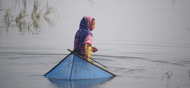 Teenager Hasina Begum fishing in the salty Kholpetua River in southwestern Bangladesh. 