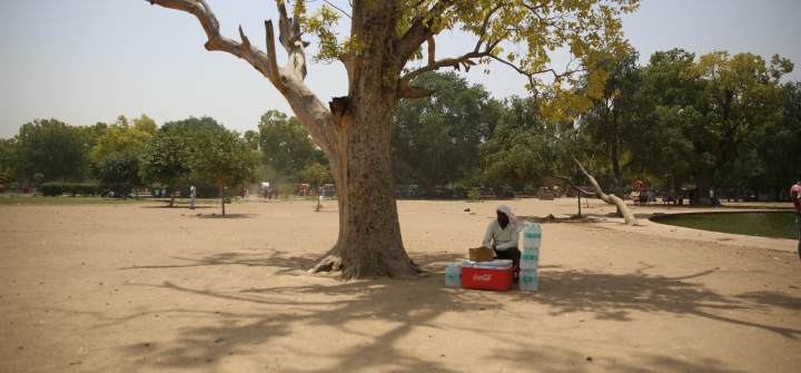 A man takes rest from selling water bottles on a hot afternoon near India Gate in Delhi. 