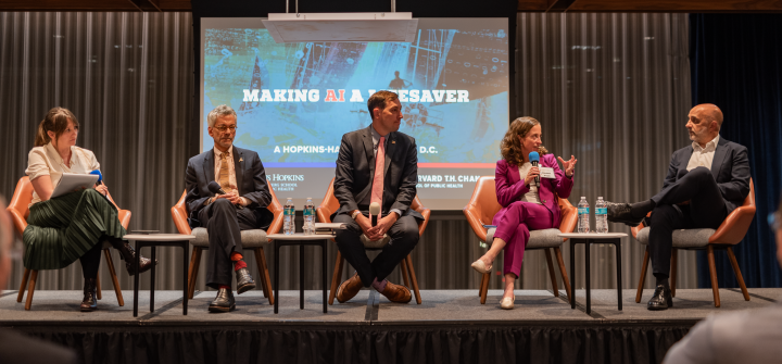 Biostatistician Elizabeth Stuart (in purple) makes a point to HHS assistant secretary Micky Tripathi; other AI event panelists (l to r): Alison Snyder, John Auerbach, and Jesse Ehrenfeld. 