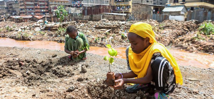 Local teenage girls resident of Kiamako slum take part in planting a tree near a site of homes destroyed by floods along the bank of Mathare river. Nairobi, Kenya, June 5, 2024. 