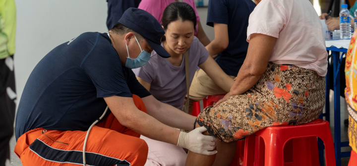 A member of China Search and Rescue Team provides medical consultations for local residents in Mandalay,  Burma (Myanmar),