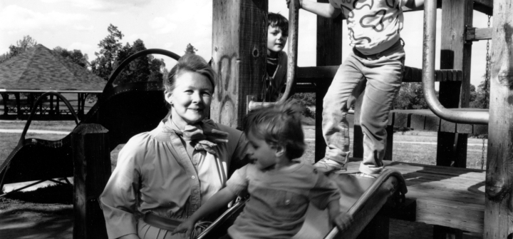 Sue Baker with children on a playground slide
