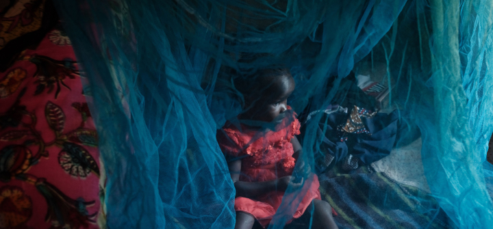 Three-year-old Faith, who completed doses through the world's first malaria vaccine (RTS, S) pilot program, plays under a mosquito net at her home in Mukuli, Kenya, on March 7, 2023.