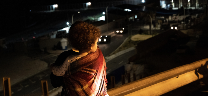 A young boy from Ceuta observes the entrance of the Tarajal beach, border between Morocco and Spanish territory of Ceuta on May 19, 2021. 